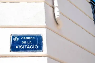 a blue and white sign on a white wall at Serene Apartment with a Relaxing Atmosphere in Valencia
