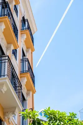a tall apartment building with balconies and trees at Serene Apartment with a Relaxing Atmosphere in Valencia