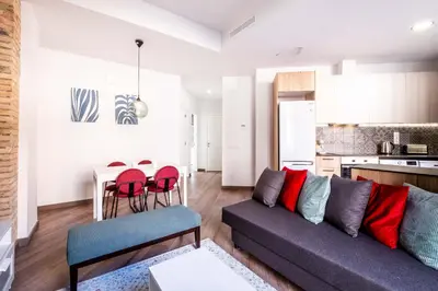 a living room with a couch and a kitchen at Serene Apartment with a Relaxing Atmosphere in Valencia