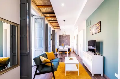 a living room with a couch and a table at Beautifully Designed Studio with Lots of Natural Light in Valencia