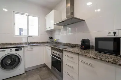 a white kitchen with a sink and a dishwasher at VLC Host - Cubells Apartments in Valencia