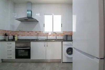 a kitchen with a sink and a washing machine at VLC Host - Cubells Apartments in Valencia