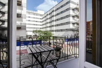 a balcony with a bench and a building at VLC Host - Cubells Apartments in Valencia