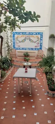 a table in a room with a bench and a wall at LA TRAVIATA - Buñol in Buñol