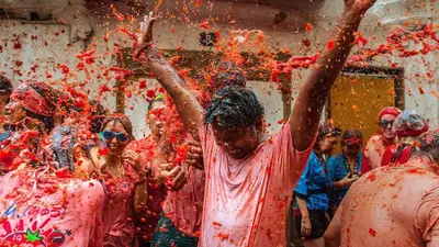 a group of people covered in red paint at LA TRAVIATA - Buñol in Buñol