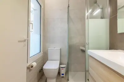 a bathroom with a toilet and a sink and a shower at ApartUP Las Arenas Beach in Valencia