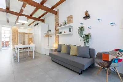 a living room with a couch and a table at ApartUP Las Arenas Beach in Valencia