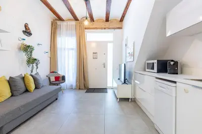 a living room with a couch and a tv at ApartUP Las Arenas Beach in Valencia