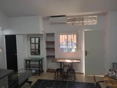 a room with a table and chairs and a window at Loft puerto de Valencia in Valencia