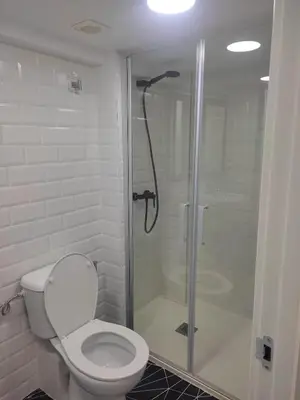 a bathroom with a toilet and a glass shower at Loft puerto de Valencia in Valencia