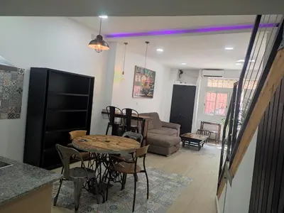 a living room with a table and a couch at Loft puerto de Valencia in Valencia