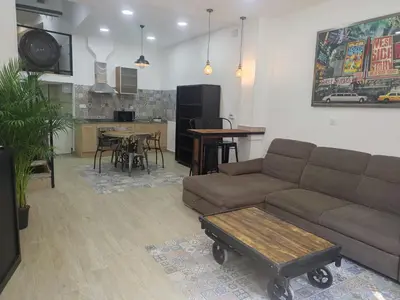 a living room with a couch and a table at Loft puerto de Valencia in Valencia