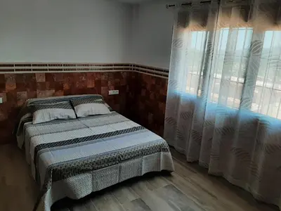 a bedroom with a bed and a window at EL ARA DE LOS ORISHAS in Siete Aguas