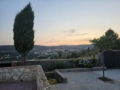 a view of a city from a patio with a tree at EL ARA DE LOS ORISHAS in Siete Aguas