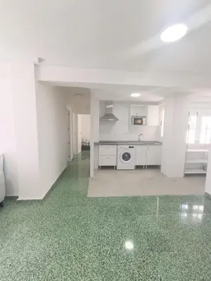 a white kitchen with a stove and a dishwasher at Apartamento Lyon in Cullera