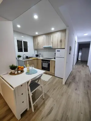 a kitchen with a table and a counter top at Near Beach Cullera in Cullera
