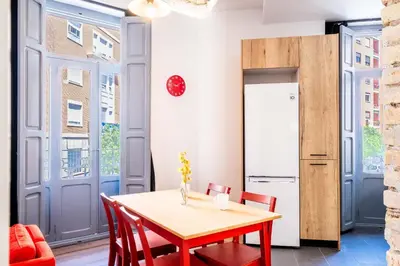 a dining room with a table and chairs and a refrigerator at Quality Apartment with Homely Decor in Valencia