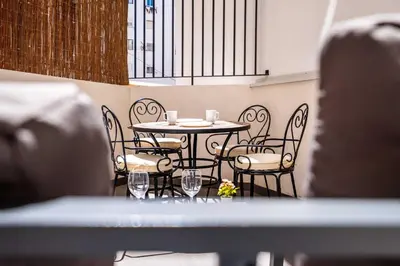 a table and chairs with wine glasses on it at Quality Apartment with Homely Decor in Valencia