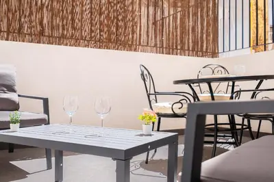 a table and chairs with wine glasses on it at Quality Apartment with Homely Decor in Valencia