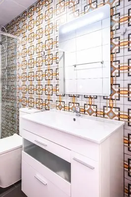 a bathroom with a white sink and a mirror at Quality Apartment with Homely Decor in Valencia
