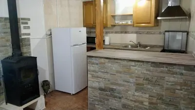a kitchen with a white refrigerator and a stove at Casa de pueblo García Marquez in Geldo