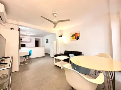 a small living room with a table and chairs at Malvarrosa Beach in Valencia
