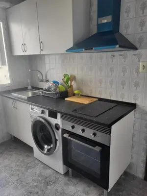 a kitchen with a washing machine and a sink at Virgen de los desamparados in Puerto de Sagunto