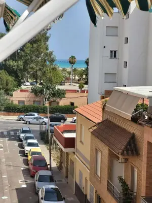 a view of a street with cars parked in a parking lot at Virgen de los desamparados in Puerto de Sagunto