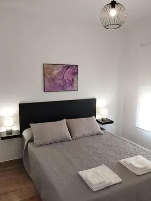 a bedroom with a bed with two white towels on it at CAN’SELMA 2 in Chella