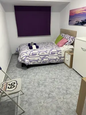 a small bedroom with a bed and a tv at Albahicín in Puerto de Sagunto