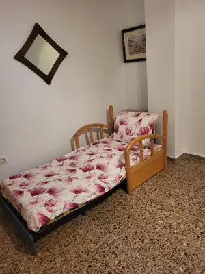 a bedroom with a bed with pink sheets at carrer de la pau port de sagunto in Valencia