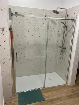 a shower with a glass door in a room at Carbonell by VivoGCFlats in Valencia