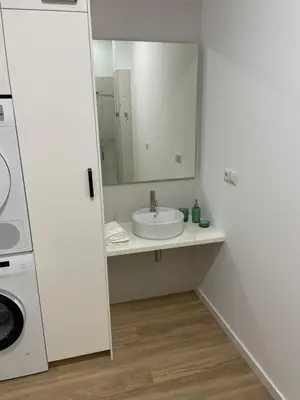 a white bathroom with a sink and a mirror at Carbonell by VivoGCFlats in Valencia