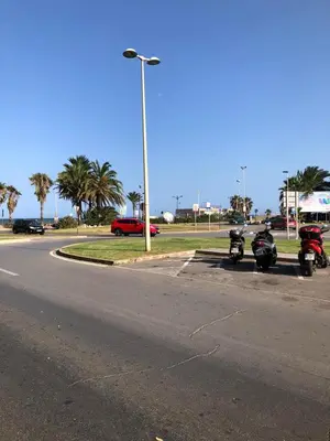 a group of motorcycles parked on the side of a street at comfortable apartment in an elite area with a beautiful veranda in Port Saplaya
