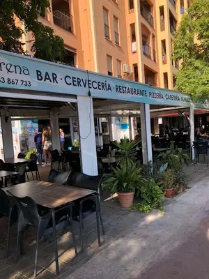 a restaurant with a table and chairs in front of a building at comfortable apartment in an elite area with a beautiful veranda in Port Saplaya
