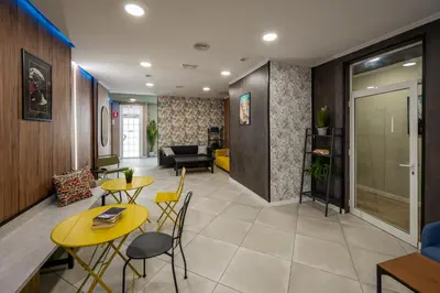 a living room with two tables and a couch at SOM Hostel Valencia in Valencia