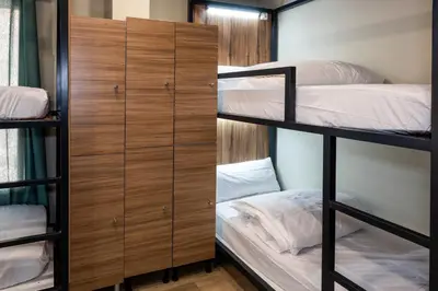 a room with two bunk beds and a closet at SOM Hostel Valencia in Valencia