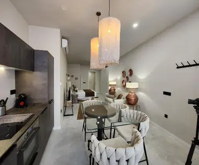 a kitchen and living room with a table and chairs at MD Pare Presentat 1 in Valencia