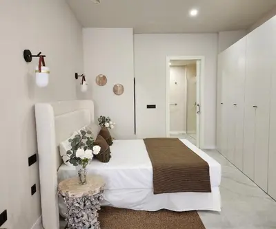 a bedroom with a bed and a vase of flowers on a table at MD Pare Presentat 1 in Valencia