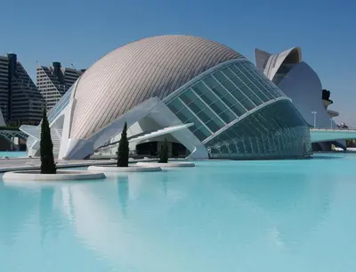 a building with a curved roof on top of water at NUEVO, a 80 metros del mar y la playa in Cullera