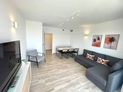 a living room with a couch and a table at NUEVO, a 80 metros del mar y la playa in Cullera