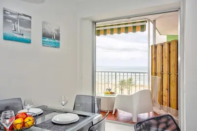 a dining room with a view of the ocean at SingularStays Cullera V in Cullera