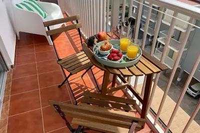 a plate of fruit on a table on a balcony at SingularStays Cullera V in Cullera