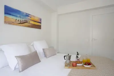 a bedroom with a bed with a tray of fruit on it at SingularStays Cullera V in Cullera