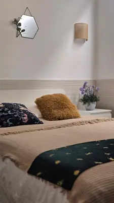 a bedroom with two beds and a lamp and flowers at Las Artes Hlius Luxury Apartments in Valencia