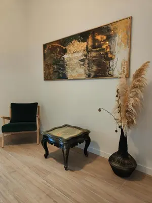 a room with a table and a chair and a painting at Las Artes Hlius Luxury Apartments in Valencia