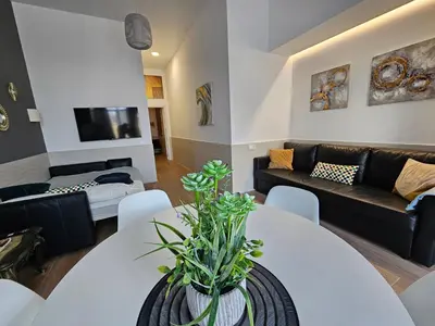 a living room with a white table and a couch at Las Artes Hlius Luxury Apartments in Valencia