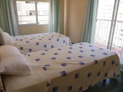 a bedroom with two beds and a window at El Raco, C-9-17 in Cullera
