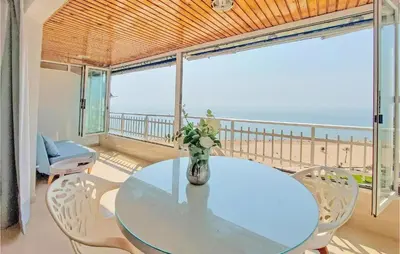 a dining room with a table and a view of the ocean at 1 Bedroom Nice Apartment In Cullera in Cullera