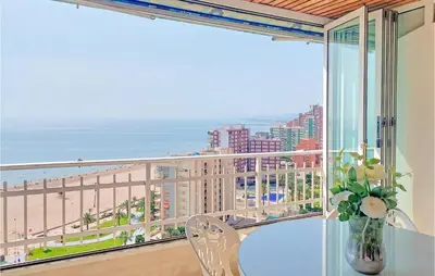 a balcony with a table and a view of the beach at 1 Bedroom Nice Apartment In Cullera in Cullera
